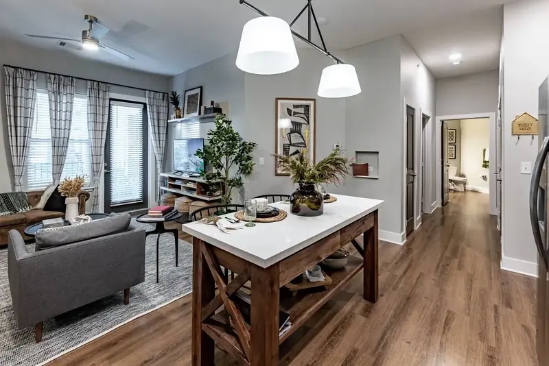 Open living and dining area with kitchen island and wood-style flooring